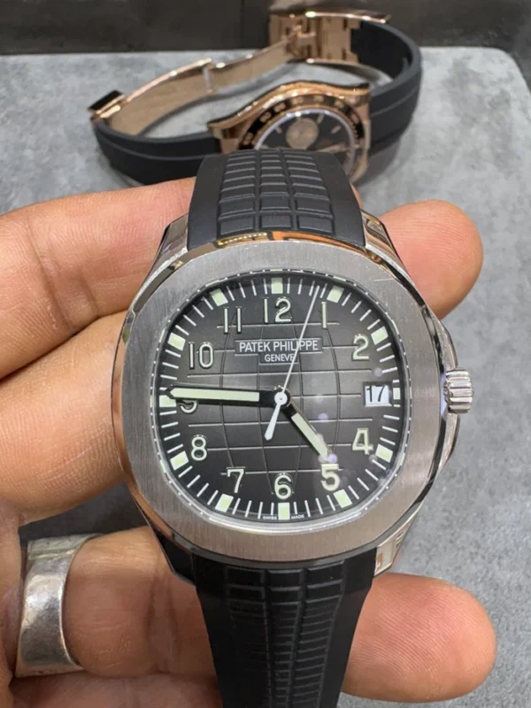 Buy Patek Philippe Nautilus 40mm in 18KT white gold with grey dial and uncut rubber strap. Iconic luxury sports watch. Guaranteed authentic.